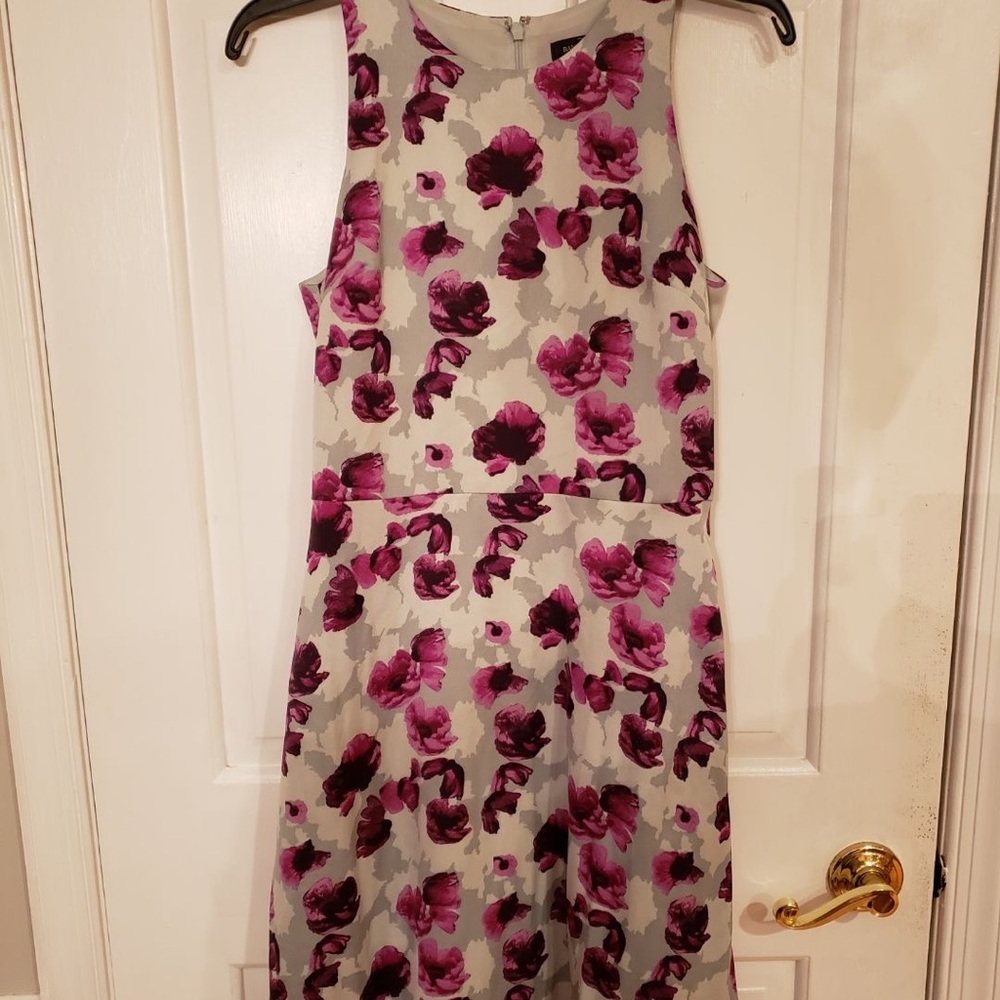 a light gray dress with purple flowers